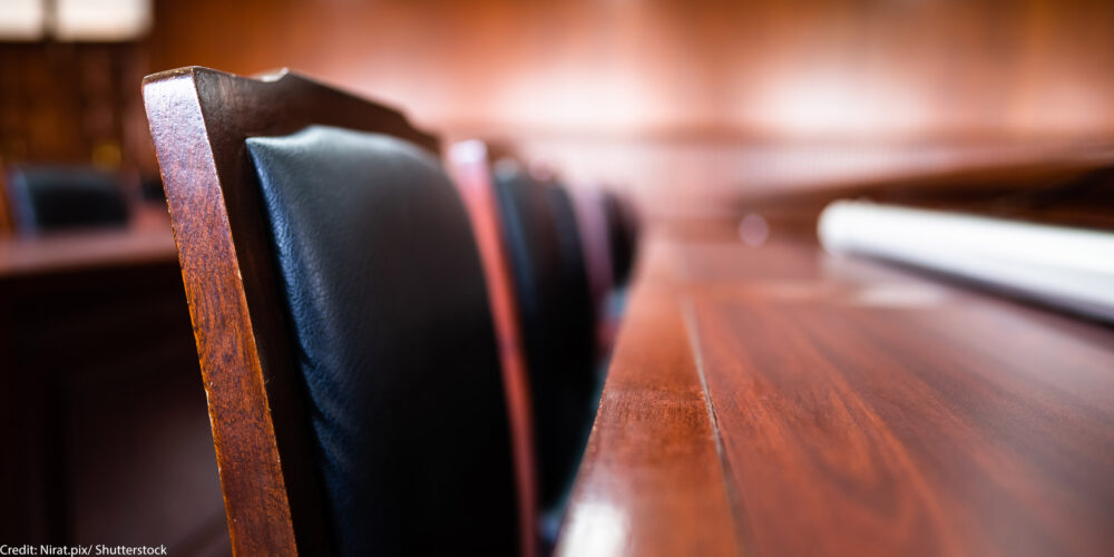 A row of jury seats in a courtroom.